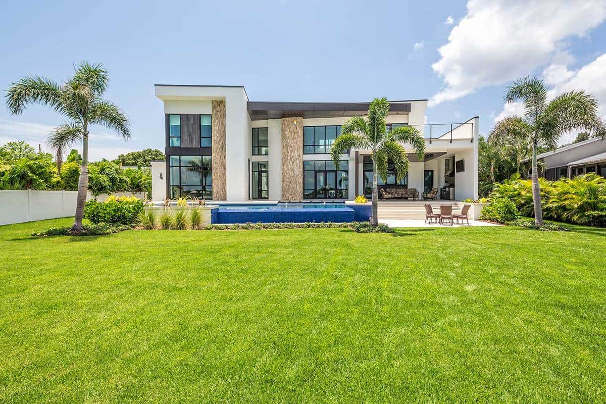A beautiful modern home with landscaped backyard, swimming pool with waterfall and spa including an outdoor sitting area with TV
