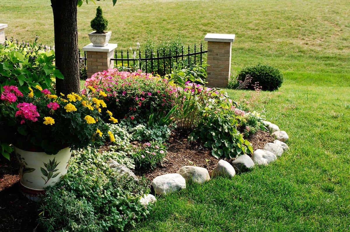 No dig garden edging made of stone in a beautiful landscaped yard