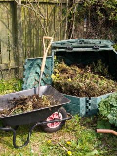 Wheel barrow with shovel and compost materials on it, Best Metal Compost Tumblers