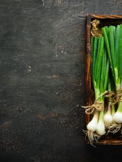 Grow onions placed on wooden container, How To Grow Green Onions Indoors?