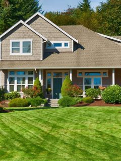 Modern country home with small windows, a huge lawn decorated with different kinds of shrubs, 13 Simple Garden Ideas To Inspire You