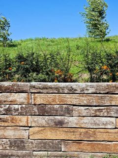 A retaining wall made out of decorative rocks, How To Build A Retaining Wall On A Slope