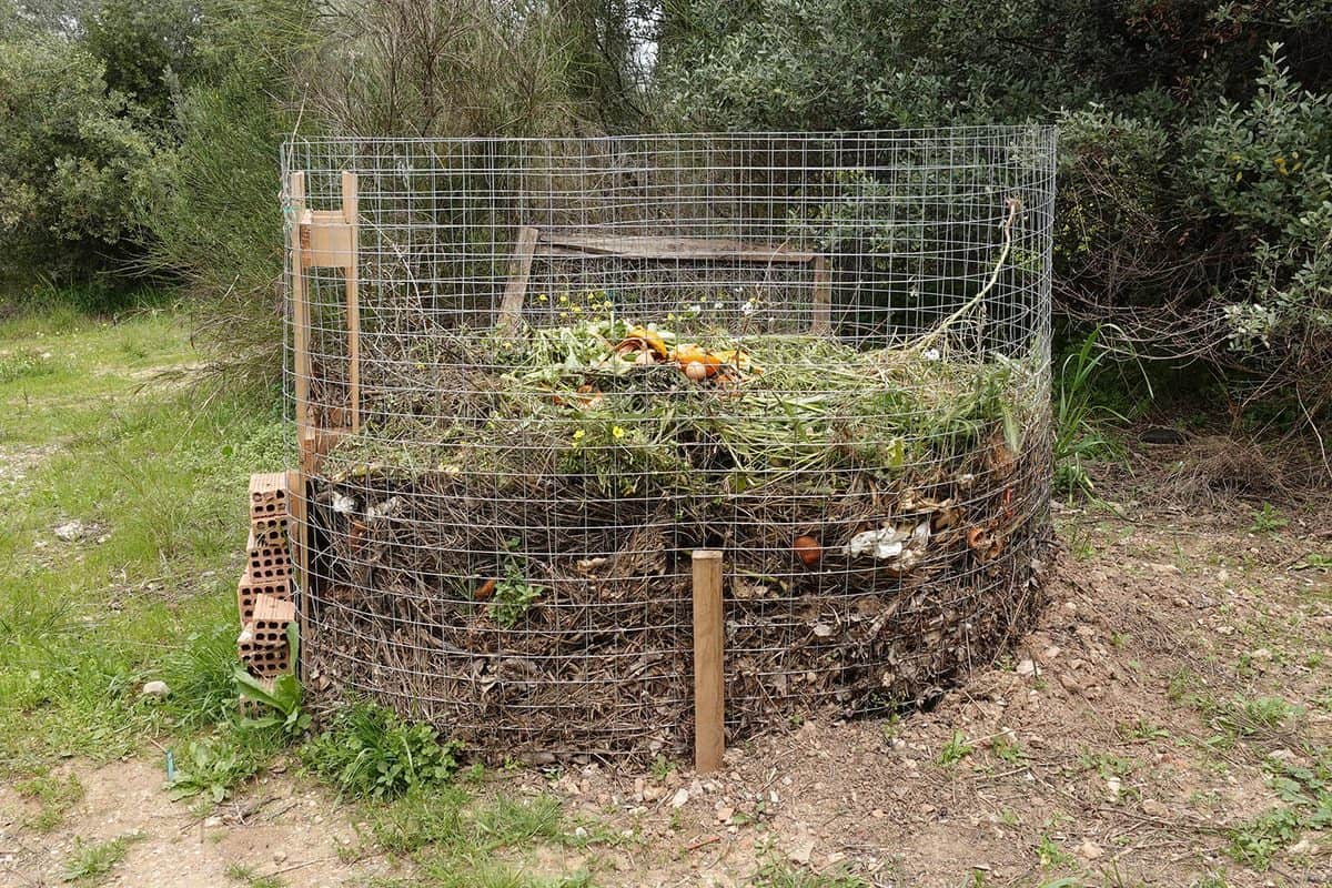 Compost pile with leaves branches food leftovers and other organic waste