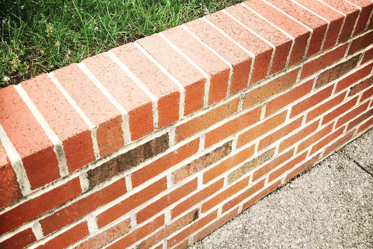 Brick Wall around Grassy Area Higher than Street Level. How Deep Should Retaining Wall Posts Be