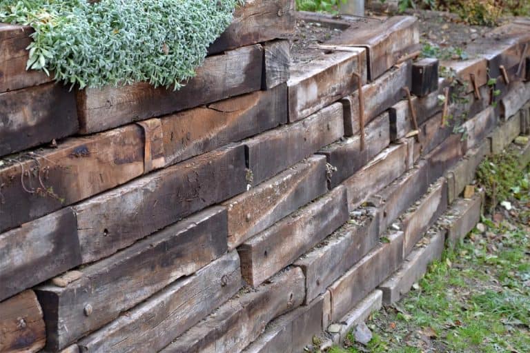 Retaining wall made of wooden sleepers, How Long Do Retaining Walls Last? [Inc. Wood Ones]