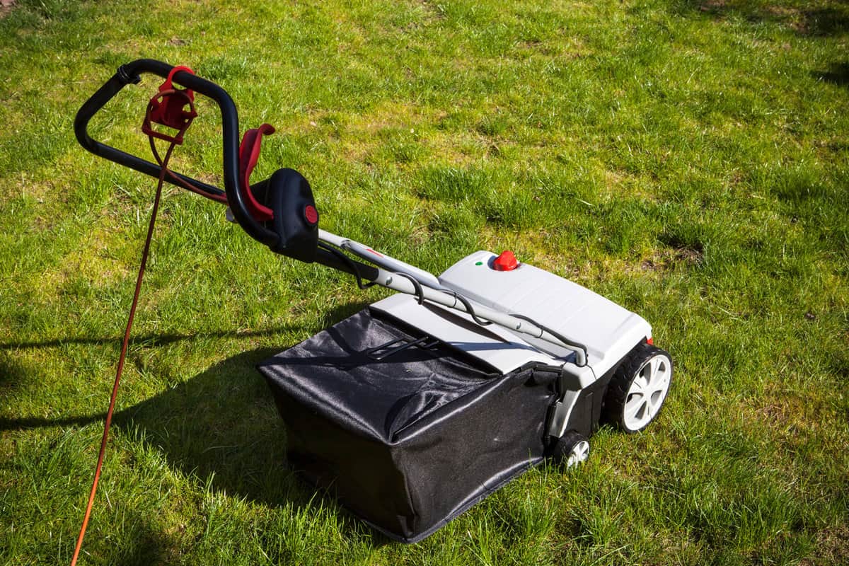 An aerator machine at the backyard lawn, Should You Aerate Before Overseeding A Lawn?
