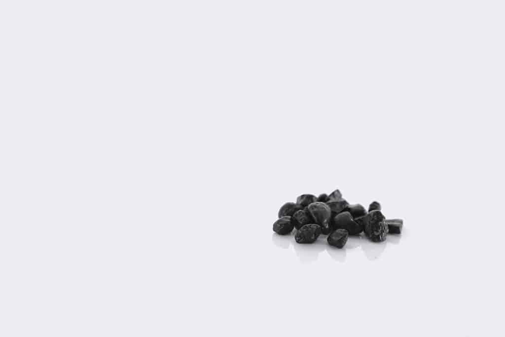 Small black pebbles on a white background