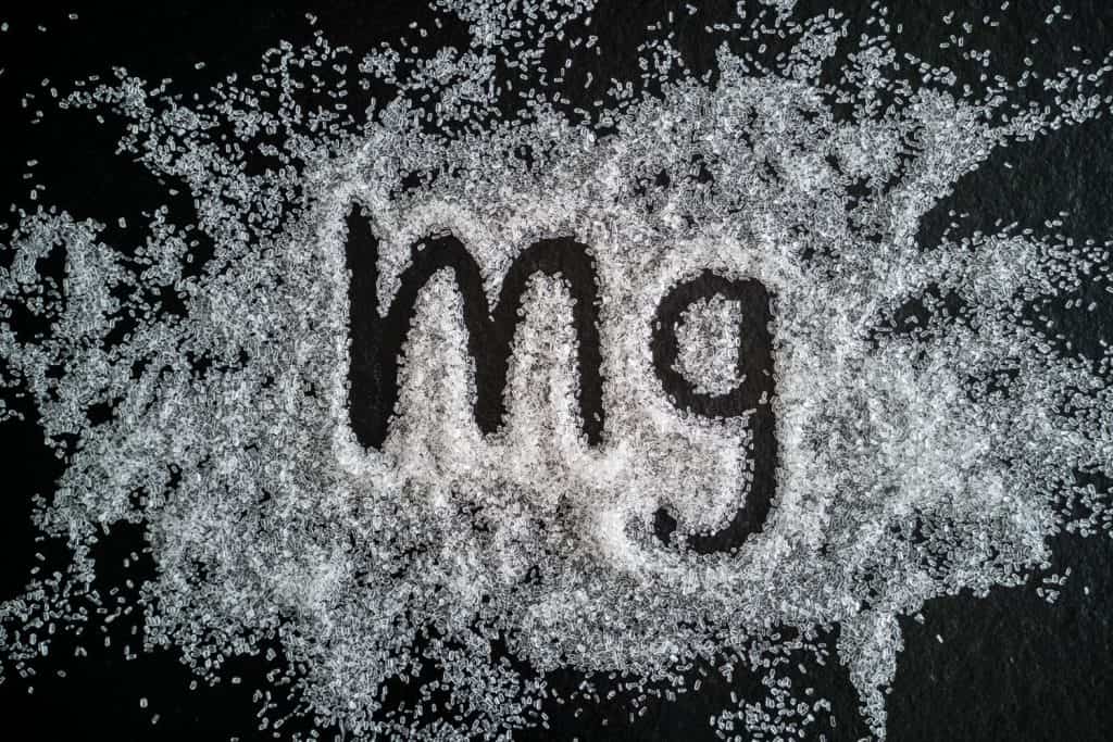 The word MG drawn in salt