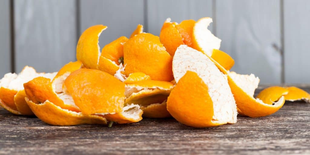 peel from tangerines peeled on a wooden table, orange peel to throw in the trash