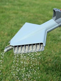 Lawn Fertilizer Being Spread By A Hand Held Spreading Machine To Feed And Treat Grass, Will Lawn Fertilizer Make Weeds Grow?