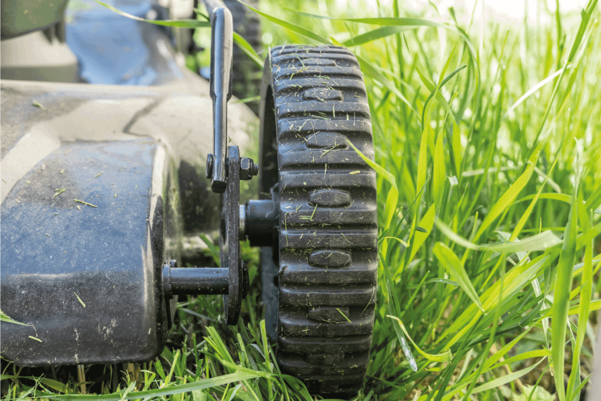 Wheels on electric lawn mower in garden to cut grass in yard