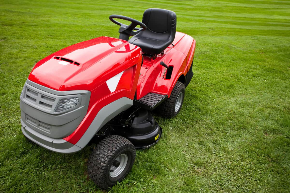 A red colored riding lawn mower used for a golf course