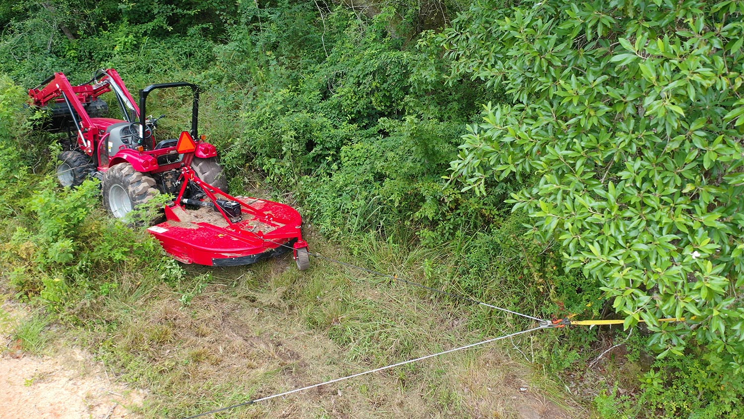 Four wheel drive tractor with brush cutter