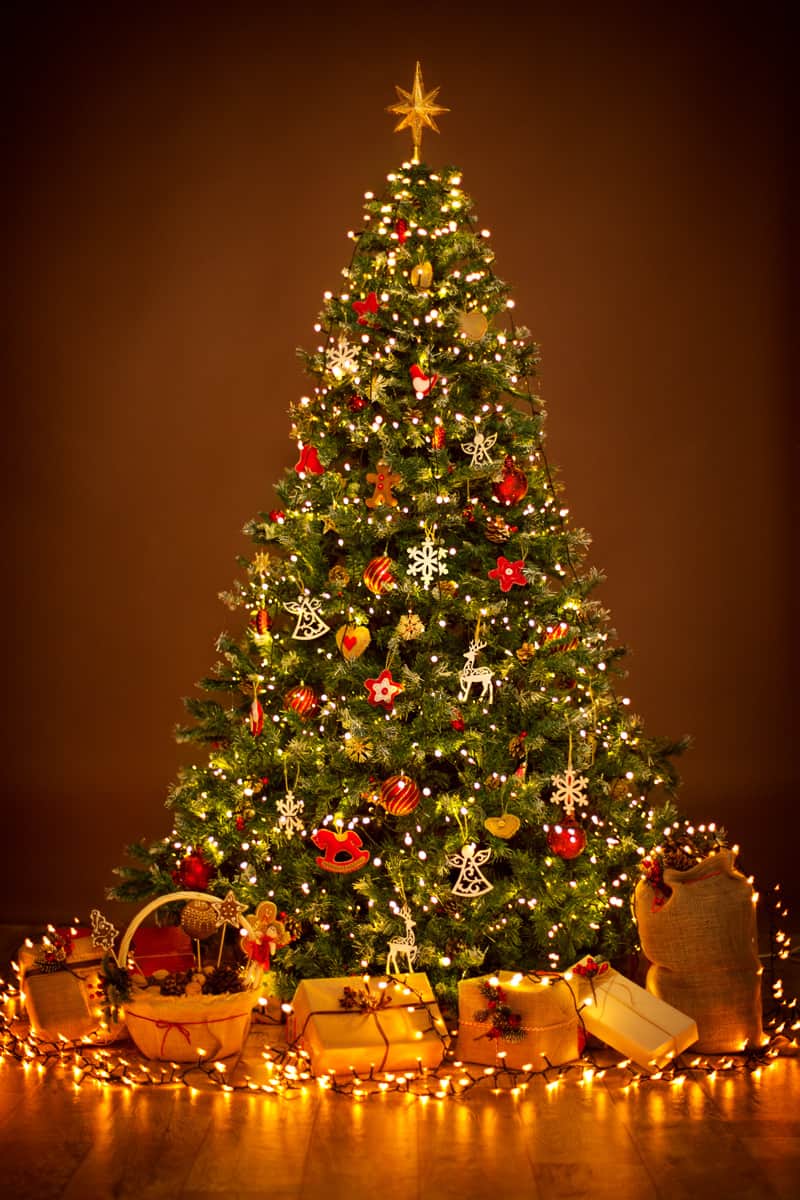 A Christmas tree decorated with christmas balls and presents