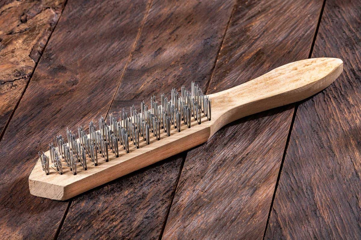 Brush with steel wire bristles with wooden handle