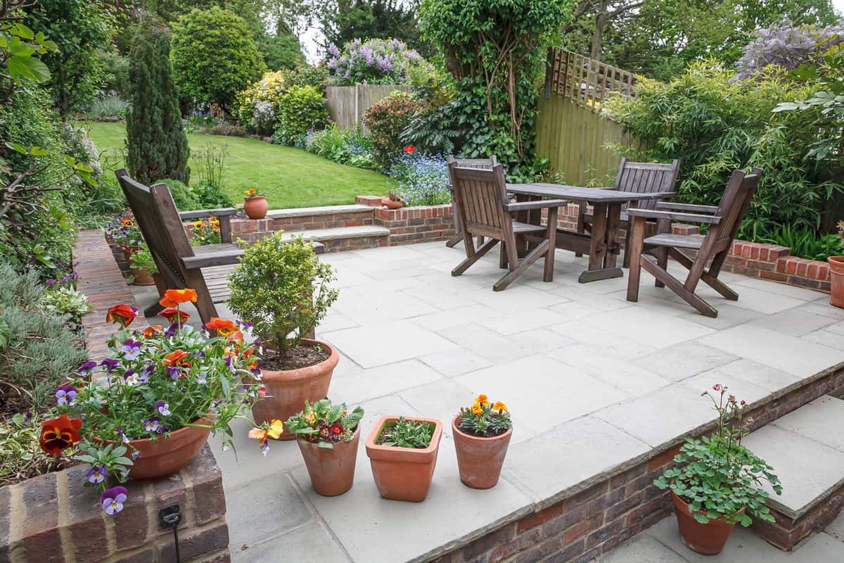 Hard landscaping, new luxury stone patio and garden of an English home, UK