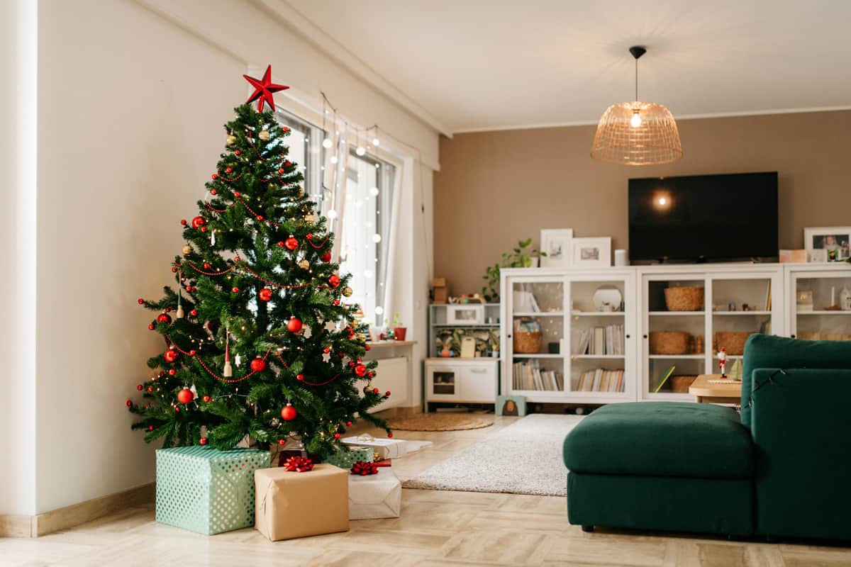 Interior of a modern house with a Christmas tree on the corner celebrating the Holidays