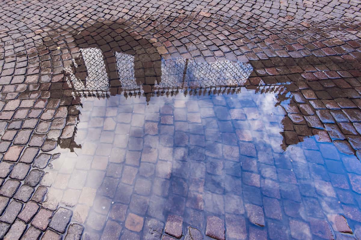Puddle reflecting a blue sky