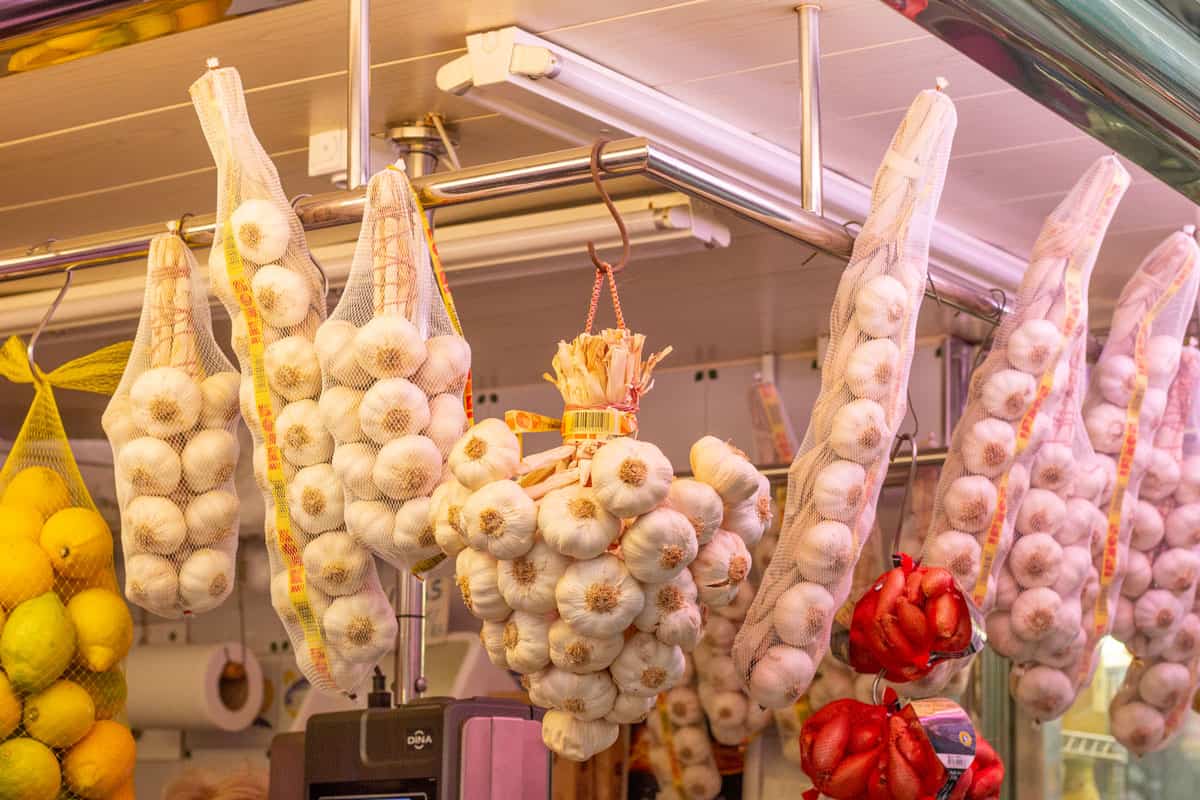 grocery store selling garlic. bagged garlic bulbs