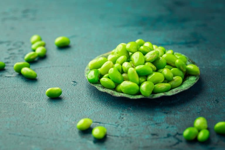 Bowl of raw edamame beans on cyan color desk, Can You Grow Edamame From Frozen?