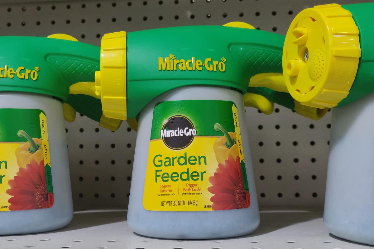 Plastic bottles of miiracle gro garden feeder on store shelf