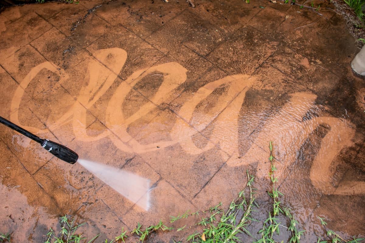 Staining Does the Fixing - Cleaning backyard paving tiles with pressure washer. Spring clean up