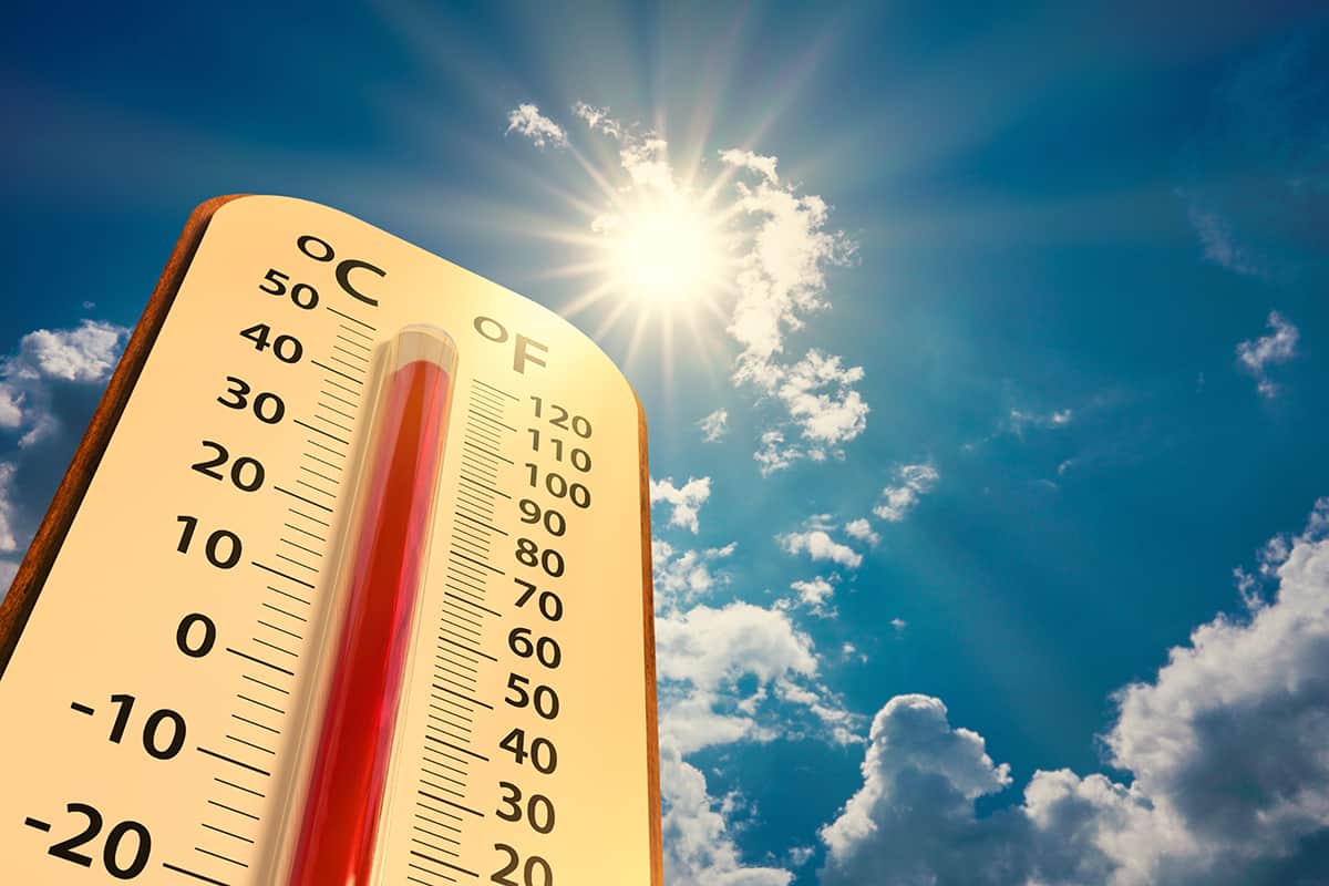 Thermometer on blue sky with sun shining in summer show increase temperature