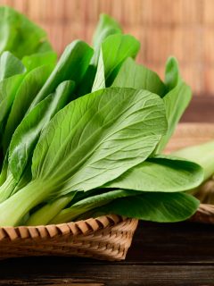 Fresh Bok Choy or Pak Choi(Chinese cabbage) in bamboo basket on wooden background, Organic vegetables. - What Is Eating My Bok Choy Leaves [And How To Prevent It]?