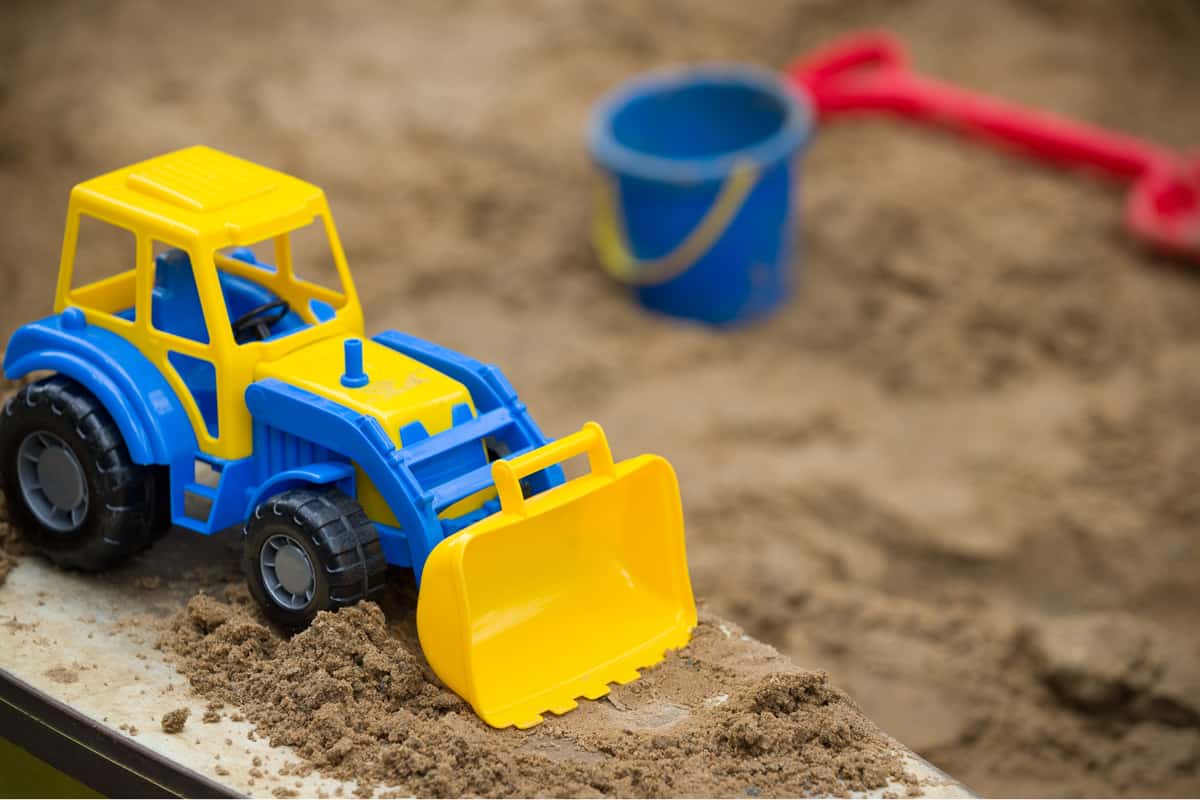 A small toy bulldozer in the kids playing area