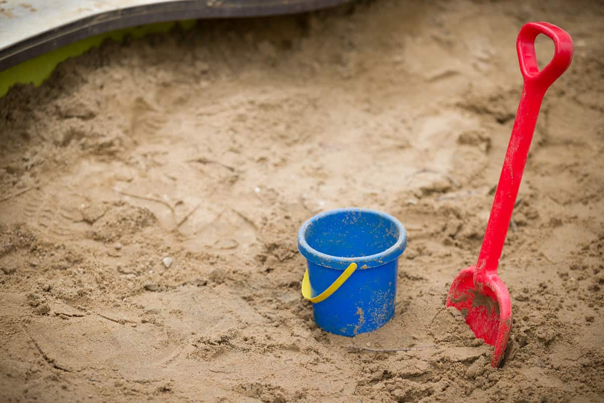 Bucket and red shovel on the sand