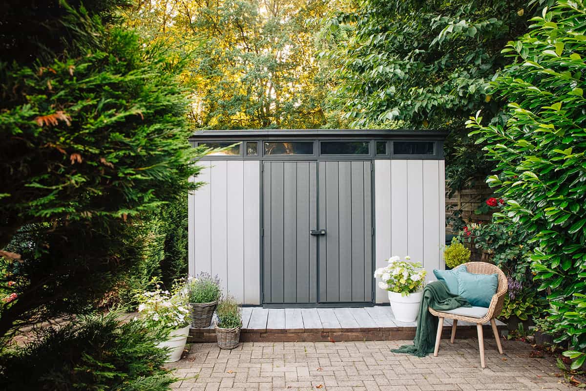 Gray garden shed in summer