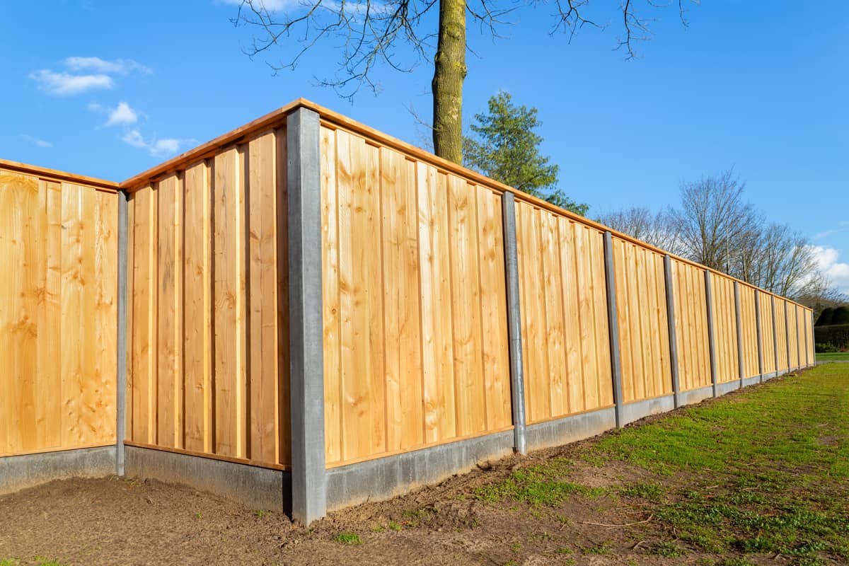 Outside built new wooden fence construction surrounding dutch garden