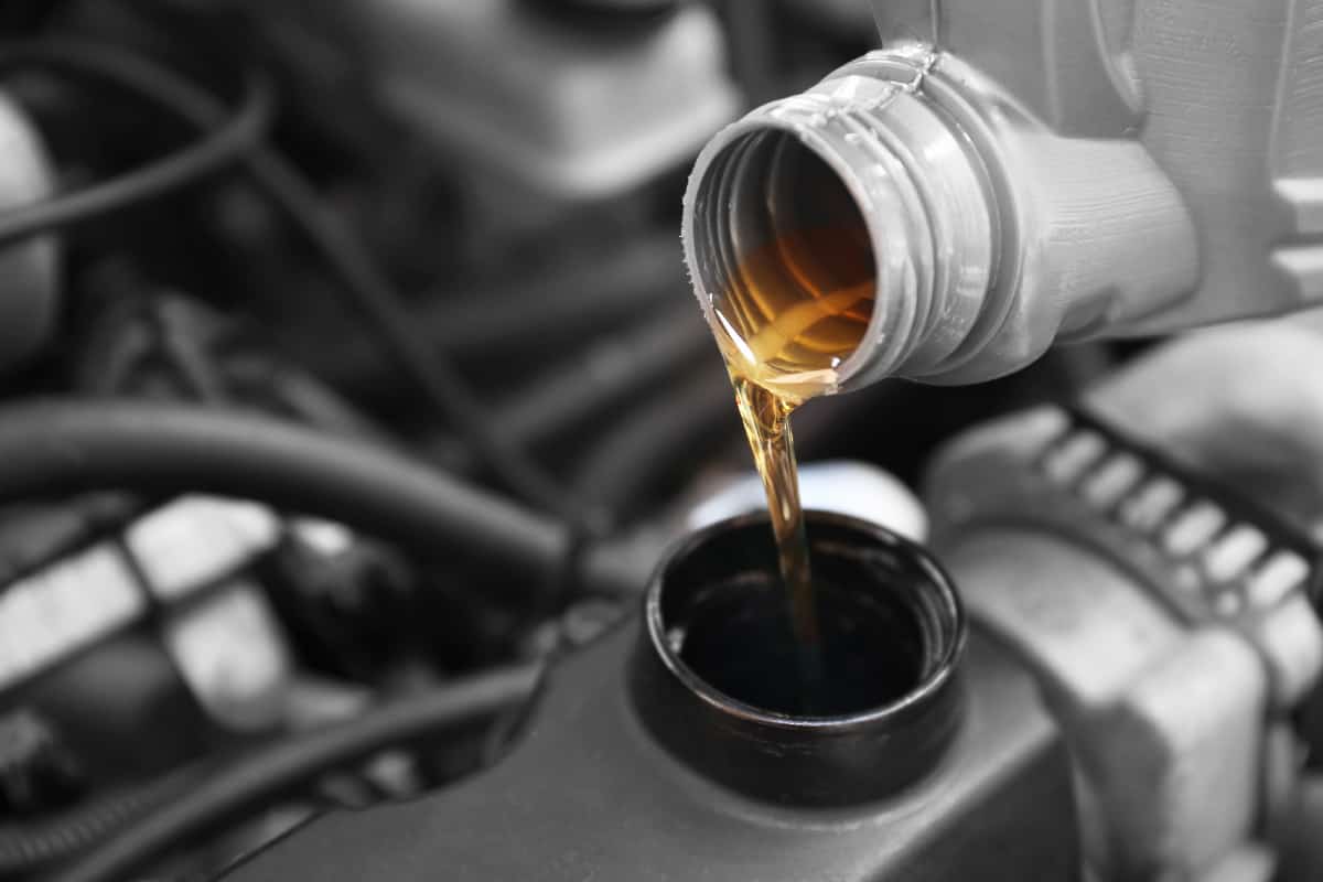 Pouring oil to car engine