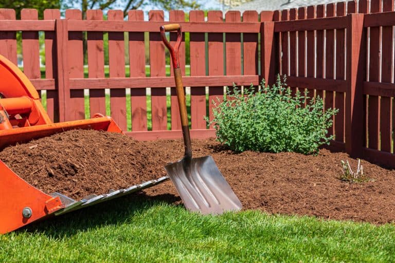 Tractor loader with wood chips or mulch and flowerbed, 20 Flower Bed Mulching Ideas You Will Love