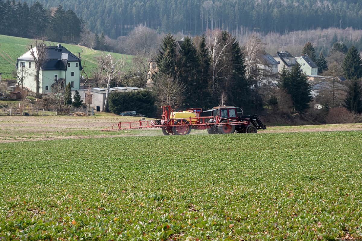 Wrapping Up - Tractor fertilizes a field in agriculture
