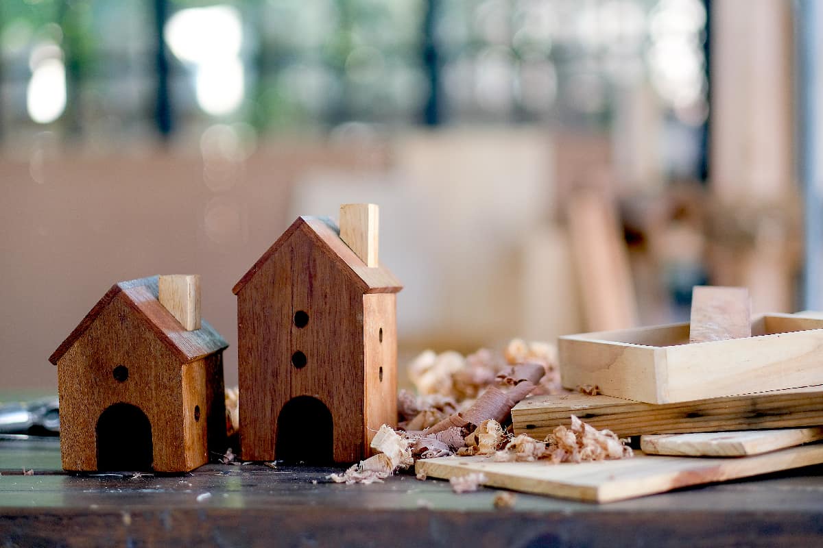 Two small wood houses or bird box are put on the table