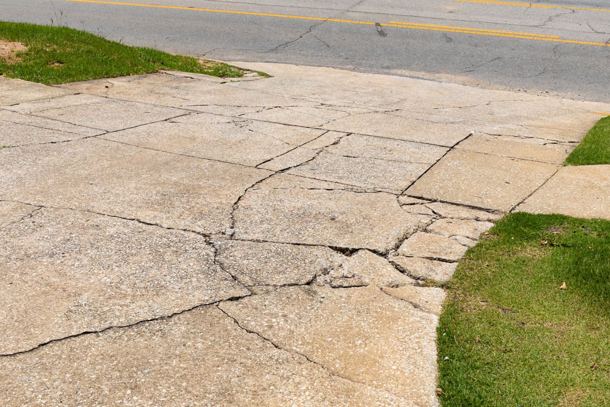 cracked-broken-aggregate-concrete-driveway-descending