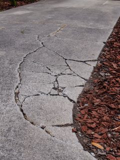 cracked-sunken-concrete-driveway-repair, How To Fix A Crumbling Asphalt Driveway [Step By Step Guide With Supplies List!]