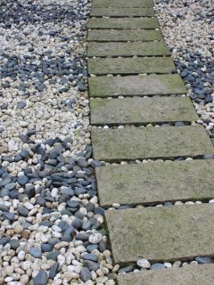 stone road background or pea gravel between pavers - How To Keep Pea Gravel In Place Between Pavers [Expert Tips]