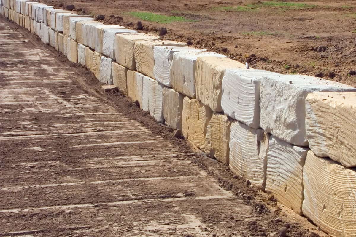 1 ton sandstone blocks fashioned into a long retaining wall during landscaping at a new estate