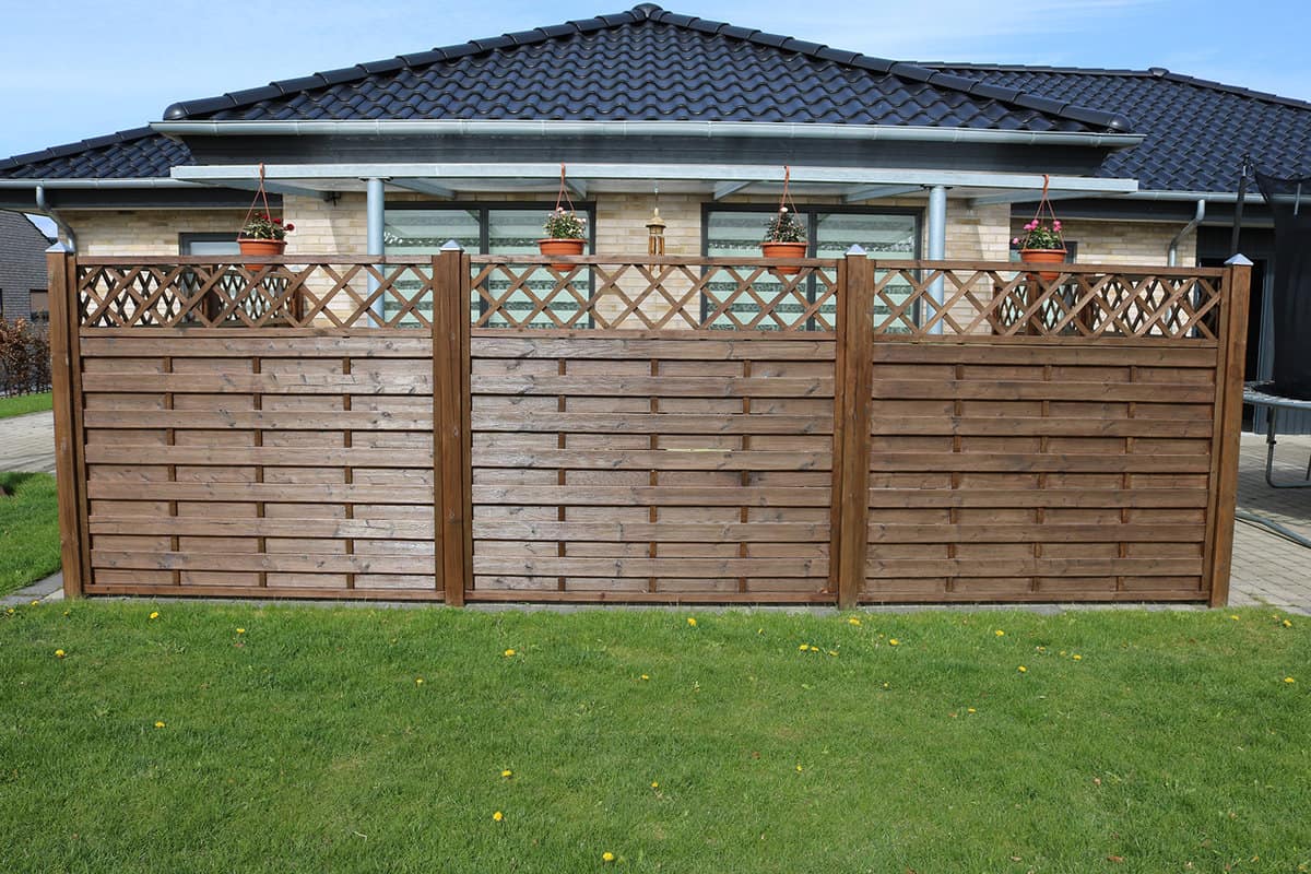 A terrace wooden fence with privacy lattice screen