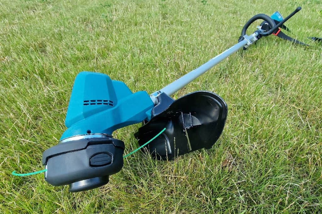 Electric grass trimmer professional gardening tool on lawn grass