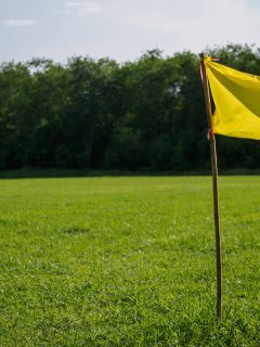 Yellow flag at corner of soccer field. sport flag and sign concept., Yellow Flags In Yard: What Do They Mean? [Here's What You Should Know!]