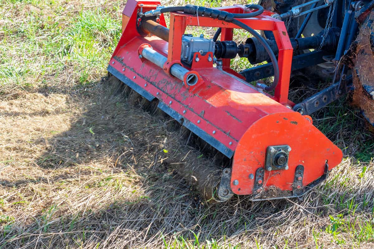 close tractor chain mower chopping dry
