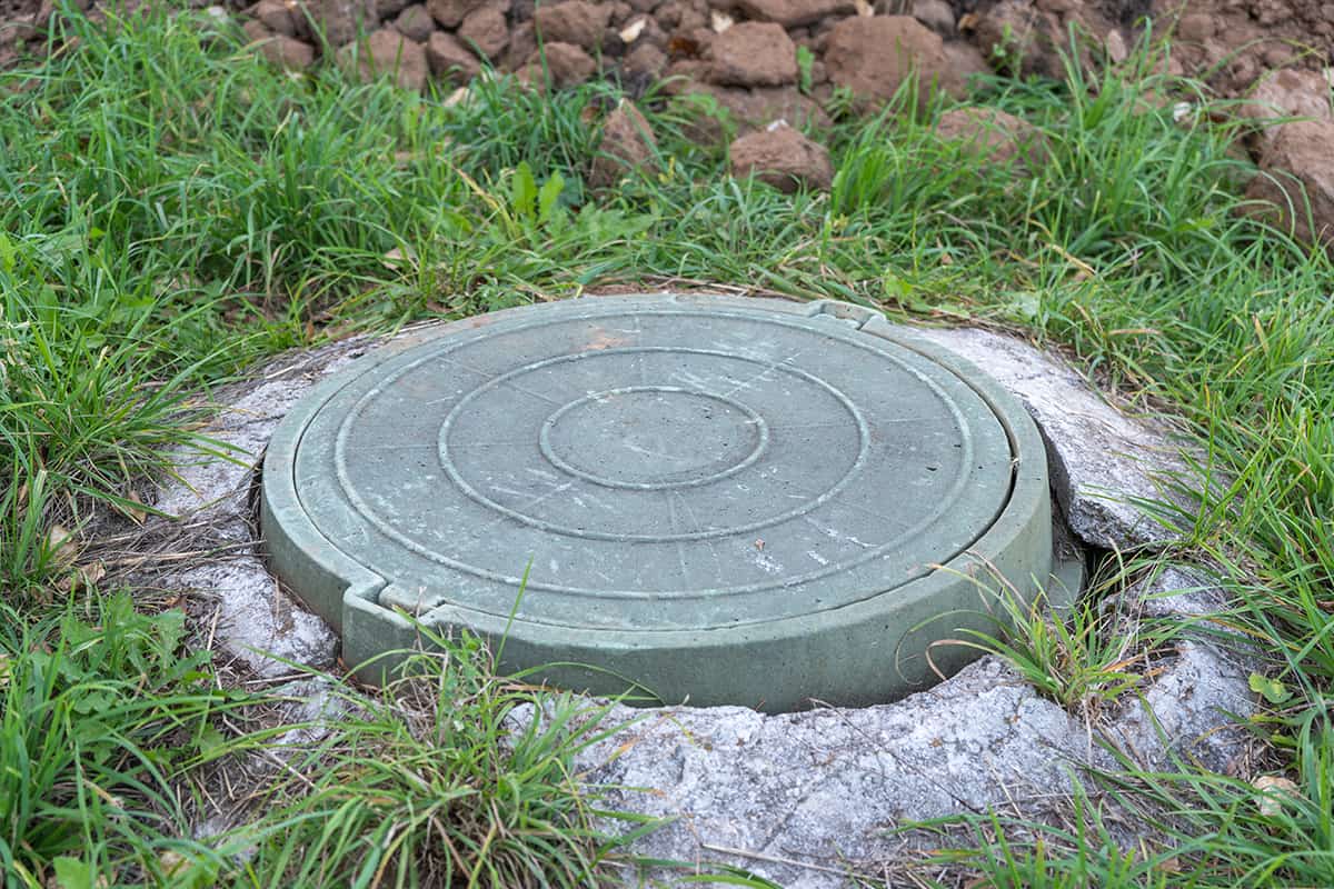 Green plastic manhole cover of the septic tank