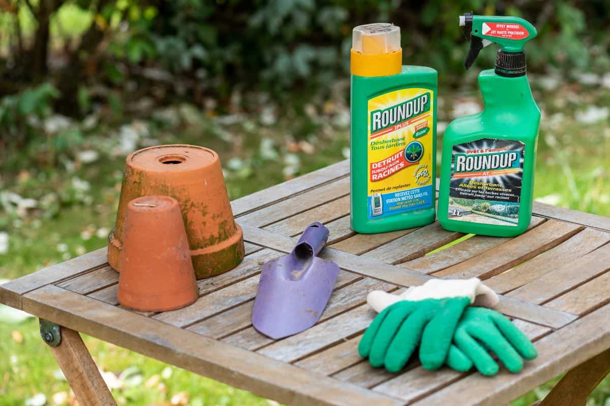 Herbicide on a wooden table in a garden