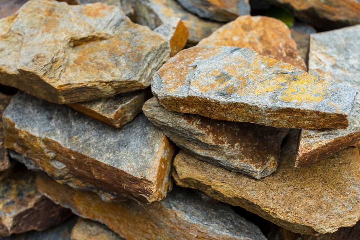 Rustic Grey and brown slate landscaping rocks for sale at a garden store or construction supply. 