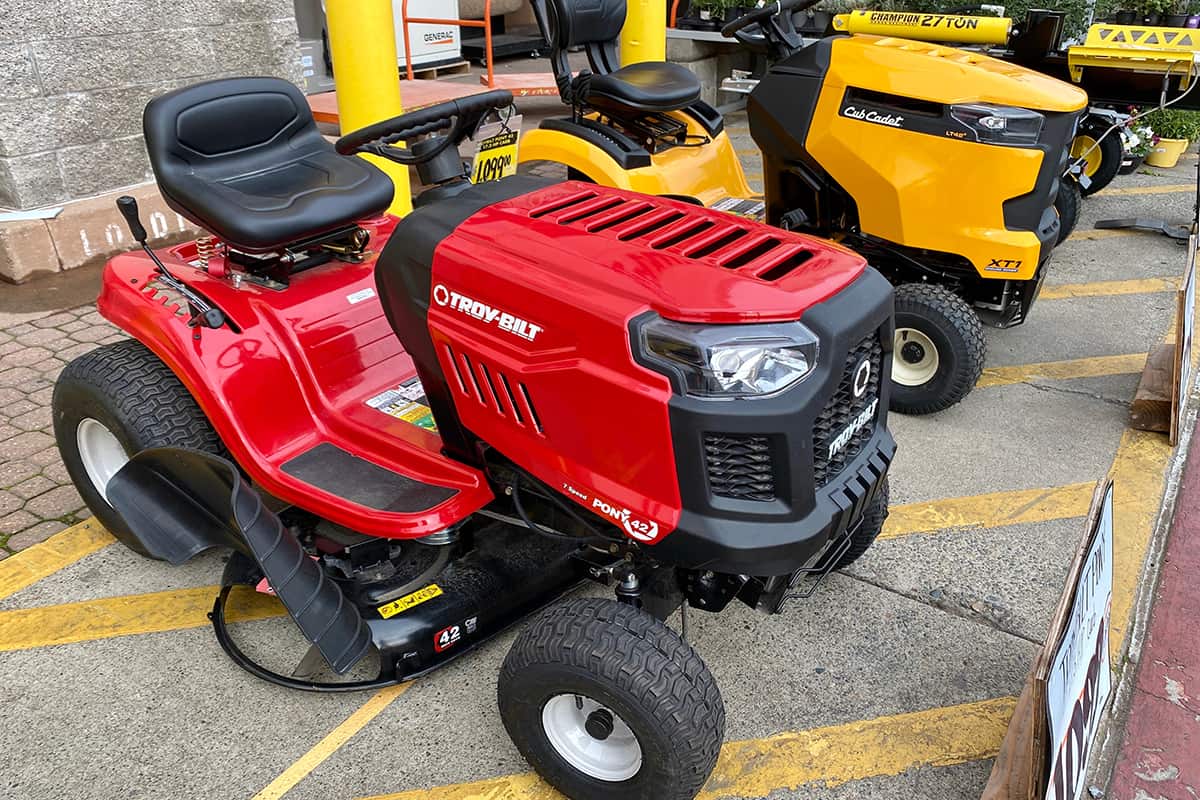 Two brands of ride-on lawn mowers for sale right outside of Home Depot