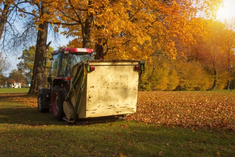 Vacuum sweeper towed by a tractor work in autumn park. Collect leafs. - My Cyclone Rake Won't Start - Why What To Do