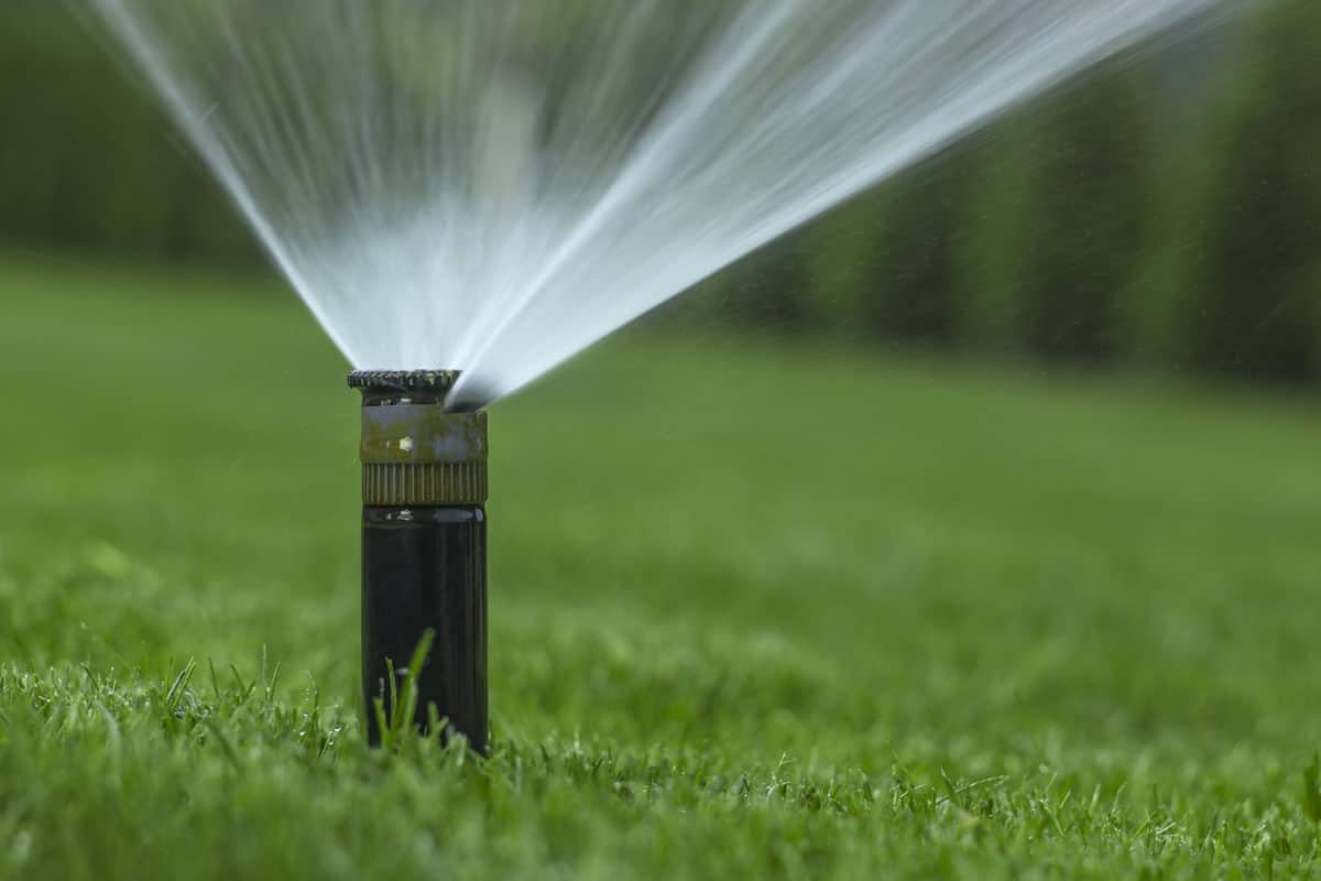 automatic sprinkler system watering lawn on
